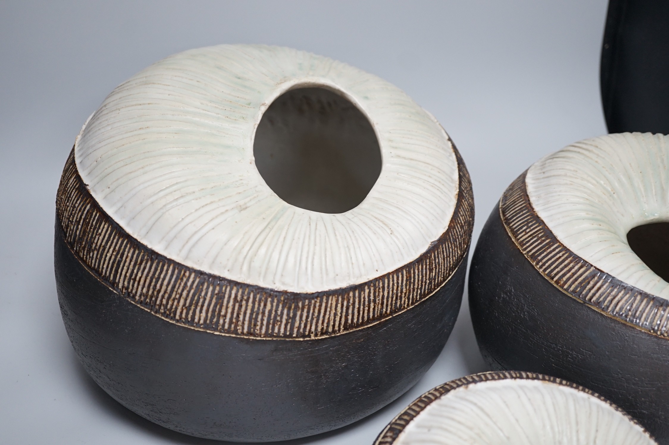 Ruth Sulke - a set of three graduated shell-like circular pottery vases, each inscribed R/S on base, tallest approximately 25cms high